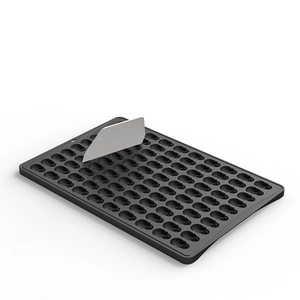 Detail of 100-cavity silicone baking mold tray with metal scraper tool for cookies