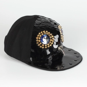 Macro detail of sequin baseball cap with owl face features and golden rivet eyes
