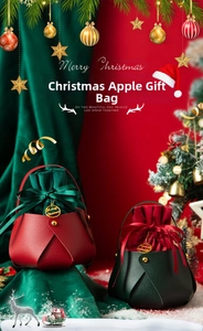 Close-up of premium leather Christmas apple gift bag with velvet drawstring and gold tag