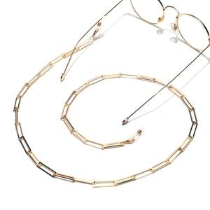 Handmade gold rectangular metal glasses chain with non-slip silicone loops on white background