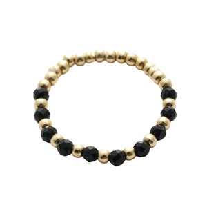 Handmade beaded ring with gold metallic beads and faceted black natural stones