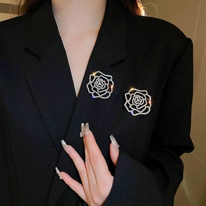 Elegant silver flower brooch with crystal rhinestones on a black suit lapel