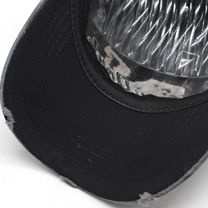 Close-up of distressed brim details on vintage embroidered cotton baseball cap