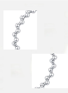 Detail of 925 sterling silver beaded ring showing polished metallic finish and texture