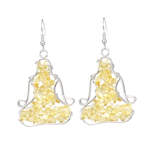 Detail of silver wire-wrapped yoga pose earrings featuring natural yellow crystal stones