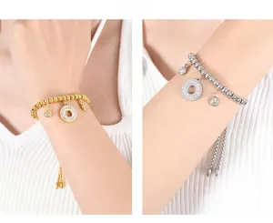 Detail of adjustable beaded bracelets in gold and silver with pave-set diamond circle charms