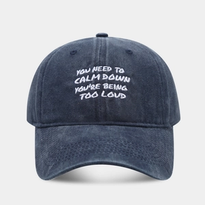 Retro washed navy denim baseball cap featuring white slogan embroidery and a soft top