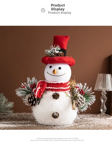 Detail of Christmas snowman with red hat, striped scarf, and natural pinecone accents