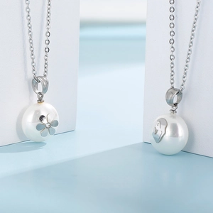 Detail of stainless steel necklaces with pearl pendants featuring flower and portrait motifs