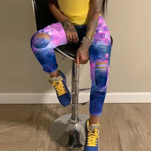 Side view of galaxy print ripped jeans with blue purple gradient on seated model