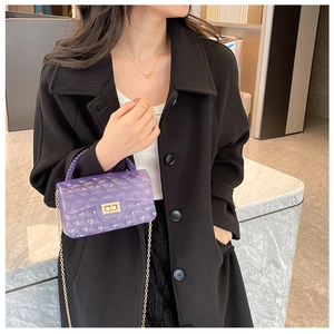Modern purple jelly crossbody bag with quilted texture and elegant pearl handle on model