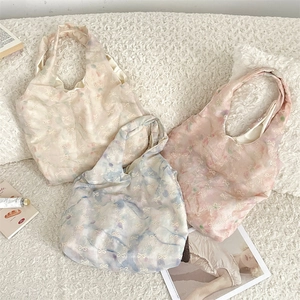 Close-up of lightweight tulle tote bags featuring delicate butterfly embroidery patterns