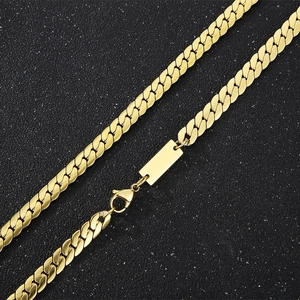 Detail of gold-tone stainless steel Cuban link necklace with rectangle engraving plate