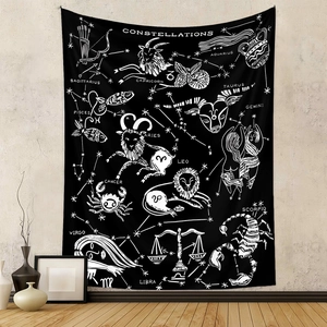 Detail of minimalist black and white zodiac tapestry with stars on a grey wall