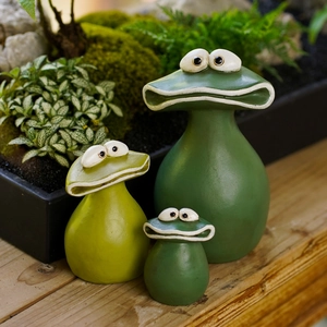 Three green resin frog garden planters in varying sizes with big eyes for outdoor decor