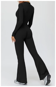 Rear view of black thermal long-sleeve yoga jumpsuit with high neck and flare leg design
