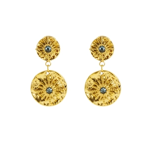 Detailed view of vintage gold starburst earrings with deep blue round crystal inlays