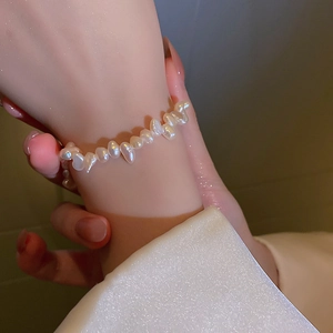Close-up of irregular Baroque freshwater pearl bracelet worn on a female wrist