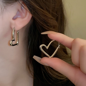 Minimalist silver heart-shaped hollow hoop earrings with a polished metallic finish