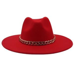 Close-up of wide brim red wool fedora hat featuring a bold gold metal chain decoration