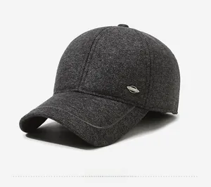 Close-up of the dark grey wool blend fabric and metal SPORT badge on the baseball cap