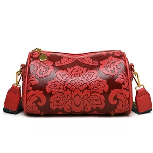Retro red cylindrical handbag with floral embossing and adjustable wide shoulder strap