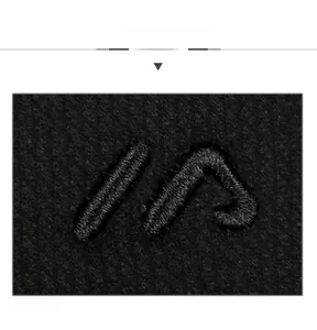 Close-up of black wool cap detail featuring premium 3D embroidered IN letters on fabric