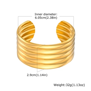 Detailed view of wide gold open cuff bracelet with dimensions showing wavy texture