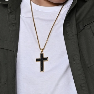 Men's large gold titanium steel cross necklace with black texture worn by a model