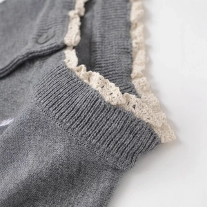 Grey knit cardigan featuring elegant white crochet lace trim along the neckline
