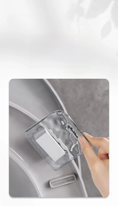 Close-up of transparent toilet lid lifter with rippled texture and adhesive backing