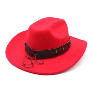 Detail of red wool felt western cowboy hat with studded brown leather band and rivets