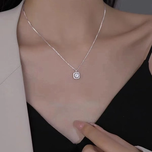 Elegant silver square pendant necklace with glittering stones on a professional model