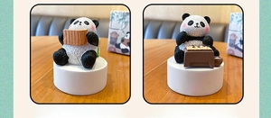 Detail of panda resin figurines calligraphy and go chess themes with fur-like texture