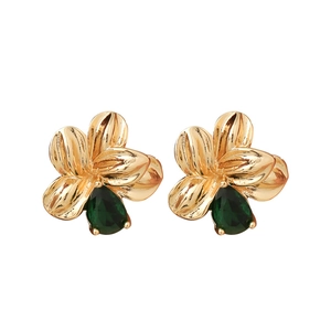 Elegant gold flower stud earrings with pear-cut emerald green crystals on white background
