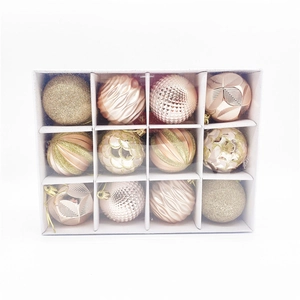 Set of 12 champagne and rose gold Christmas ornaments with various textures in a white box