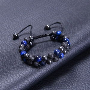 Macro detail of double-layer blue tiger eye and black lava stone braided bead bracelet