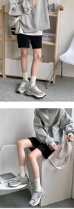 Detailed view of beige crew socks paired with vintage sneakers and casual sports outfit