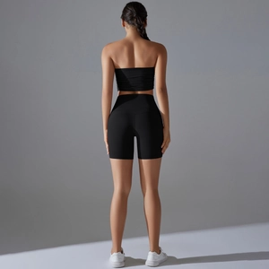 Back view of a black seamless sports bra and high-waisted yoga shorts set for women