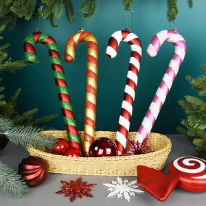 Set of four colorful Christmas candy cane ornaments with glitter and festive ribbons