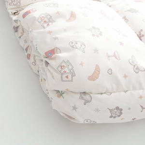 Detail der wattierten weißen Baumwolljacke mit Croissant- und Erdbeerdruck und Metall-Reißverschluss