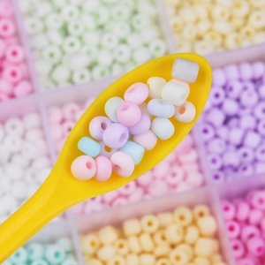 Colorful 4mm frosted glass seed beads for DIY jewelry making shown in a yellow spoon