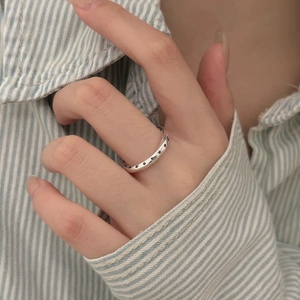 Detail of 925 sterling silver vintage star ring worn on finger with casual shirt