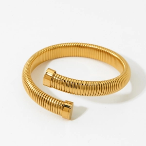Minimalist gold spiral open spring bangle in a sleek snake style silhouette