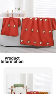 Detail showing embroidered fruit patterns on coral fleece towels with wavy hem edges