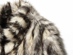 Detailed macro shot of grey and cream faux fur texture on a warm stylish coat