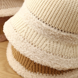Detail of chunky knit bucket hats with ribbed texture and fuzzy faux shearling trim