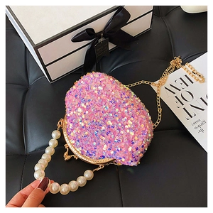 Detailed macro view of pink sequin shell bag with pearl handle and gold metal chain