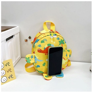 Detailed view of yellow dinosaur backpack size comparison next to a smartphone