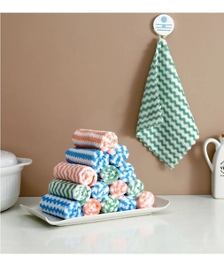 Macro detail of soft coral fleece dishcloth with wavy edges and colorful stripe patterns